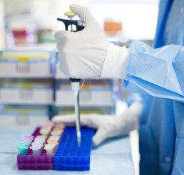 chemist holding laboratory equipment